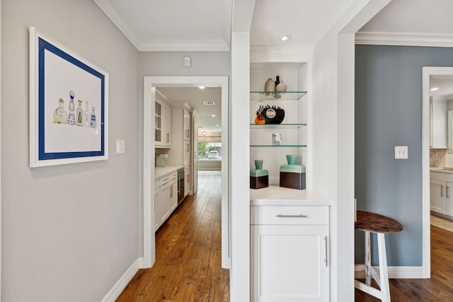 hallway with dark wood-style floors, recessed lighting, crown molding, and baseboards