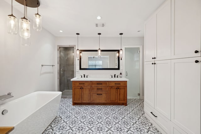 full bath with a soaking tub, a shower stall, visible vents, and a sink