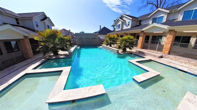 view of swimming pool featuring a pool with connected hot tub