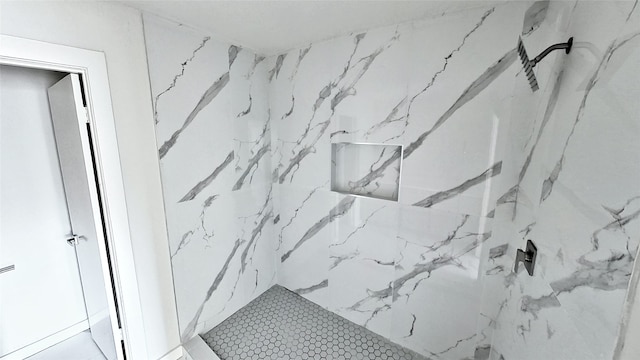 room details featuring a marble finish shower