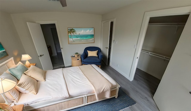 bedroom featuring a closet, wood finished floors, visible vents, and baseboards