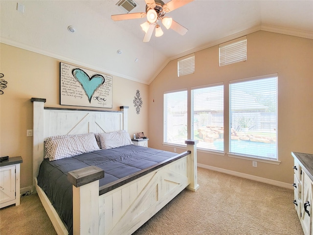 bedroom featuring lofted ceiling, light colored carpet, visible vents, ornamental molding, and baseboards