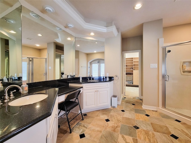 bathroom with a stall shower, a walk in closet, vanity, and recessed lighting