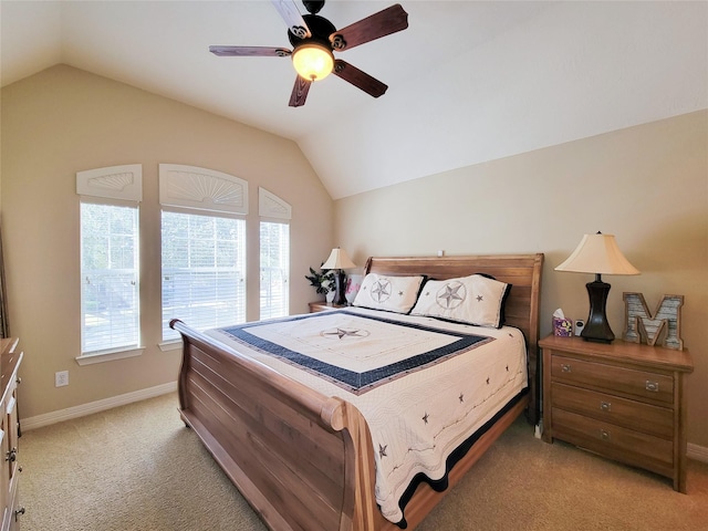 bedroom with light carpet, baseboards, vaulted ceiling, and a ceiling fan