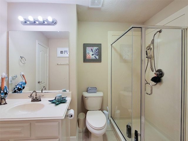 full bath with visible vents, toilet, a stall shower, vanity, and tile patterned flooring