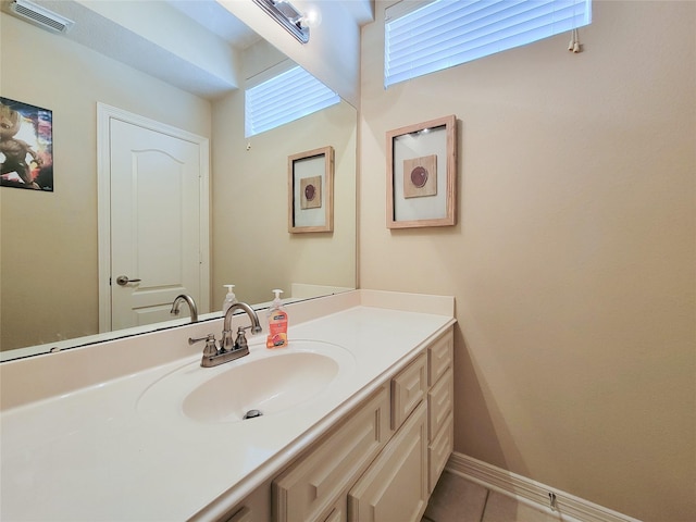 bathroom with tile patterned floors, baseboards, visible vents, and vanity