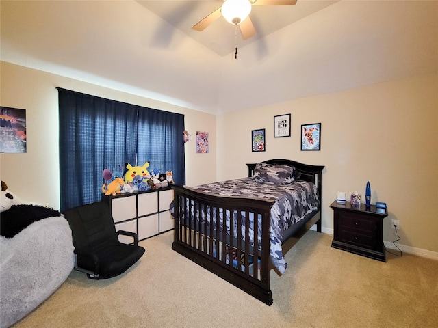 carpeted bedroom with baseboards, vaulted ceiling, and a ceiling fan