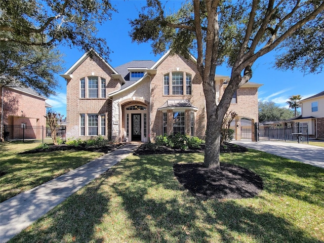 traditional home featuring brick siding, fence, and a front lawn