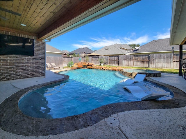 view of pool with a patio, a fenced backyard, and a pool with connected hot tub