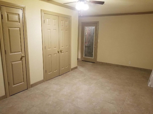 unfurnished bedroom featuring ornamental molding, ceiling fan, and baseboards