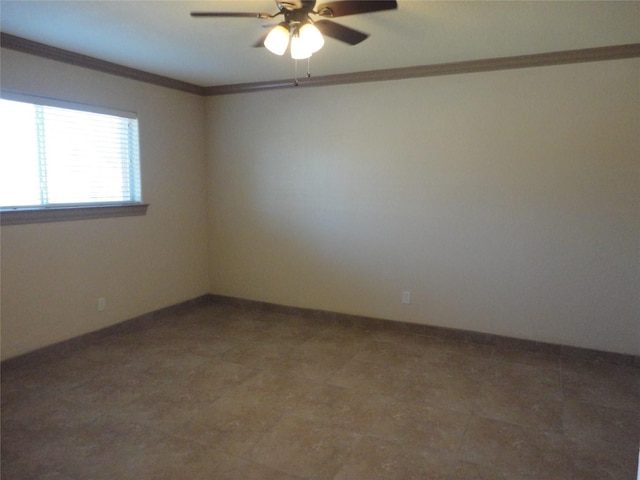 spare room with a ceiling fan, crown molding, and baseboards