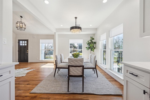 dining room with recessed lighting, baseboards, an inviting chandelier, and wood finished floors