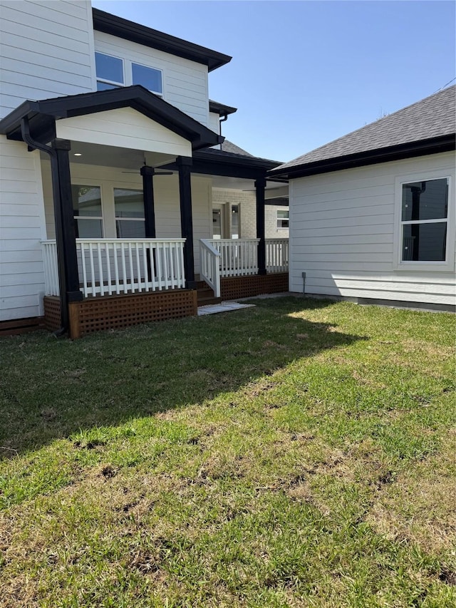 exterior space with covered porch and a yard