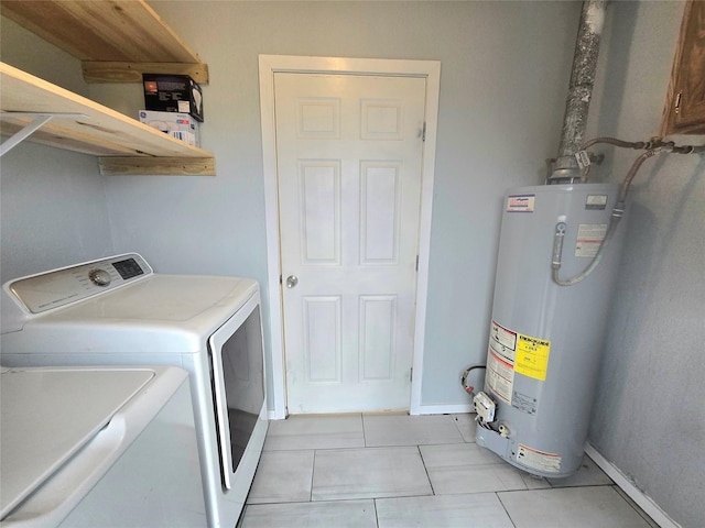 laundry room featuring light tile patterned floors, gas water heater, washing machine and dryer, laundry area, and baseboards