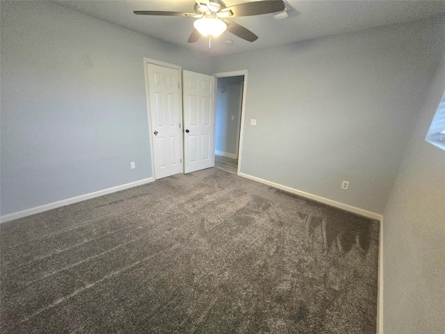 unfurnished bedroom featuring ceiling fan, carpet floors, and baseboards