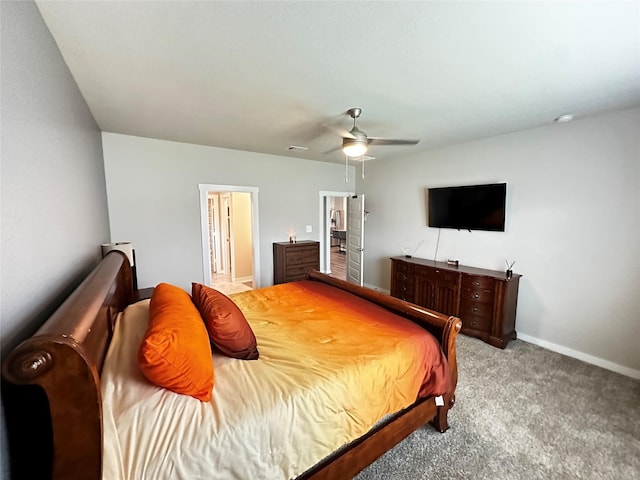 bedroom with visible vents, light carpet, ceiling fan, ensuite bath, and baseboards