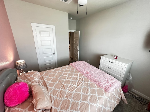 bedroom featuring ceiling fan, dark colored carpet, visible vents, and baseboards