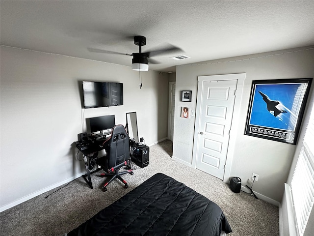 carpeted bedroom with baseboards, visible vents, and a textured ceiling