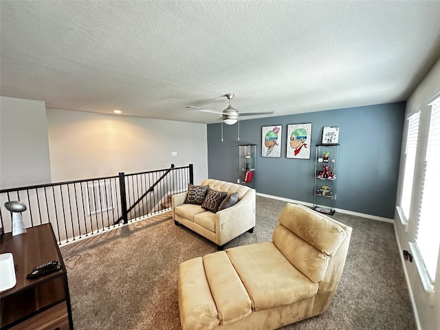 living room with dark carpet, a textured ceiling, and baseboards