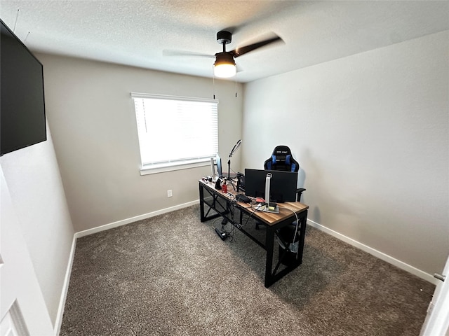 carpeted home office featuring ceiling fan, a textured ceiling, and baseboards