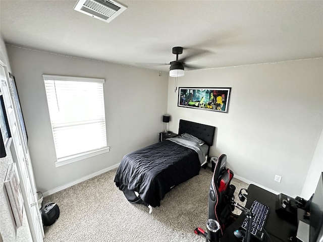 carpeted bedroom featuring a ceiling fan, visible vents, and baseboards