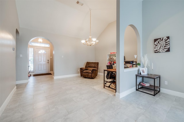 entryway with arched walkways, high vaulted ceiling, visible vents, and baseboards