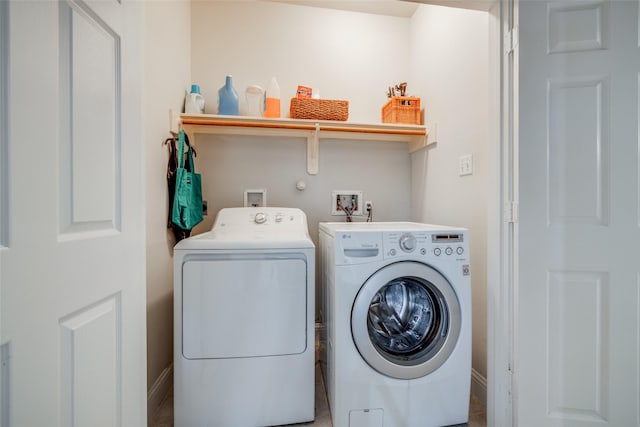 washroom with laundry area, independent washer and dryer, and baseboards