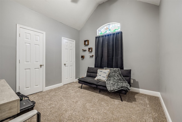 living area with carpet, lofted ceiling, and baseboards