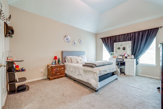 carpeted bedroom featuring vaulted ceiling and baseboards