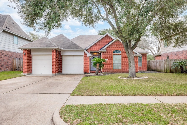 view of front of house featuring an attached garage, fence, a front lawn, and brick siding