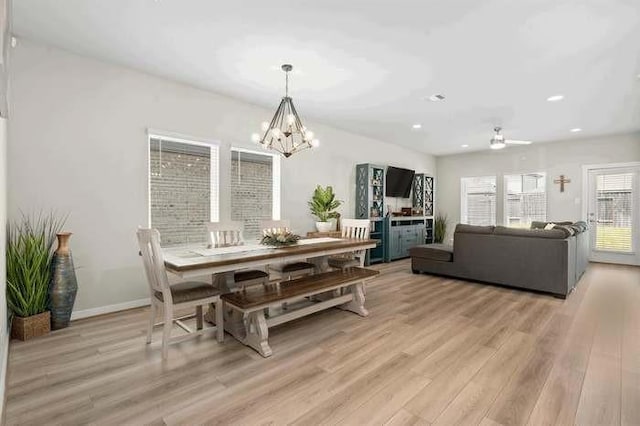 dining space featuring a notable chandelier, light wood-type flooring, baseboards, and recessed lighting