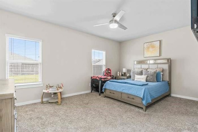 bedroom featuring ceiling fan, baseboards, and light colored carpet