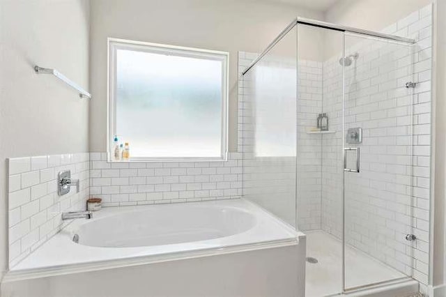 full bathroom with a garden tub and a shower stall