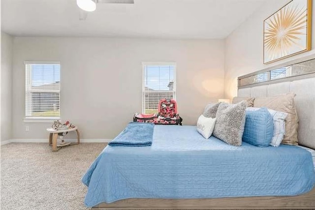 carpeted bedroom featuring ceiling fan and baseboards