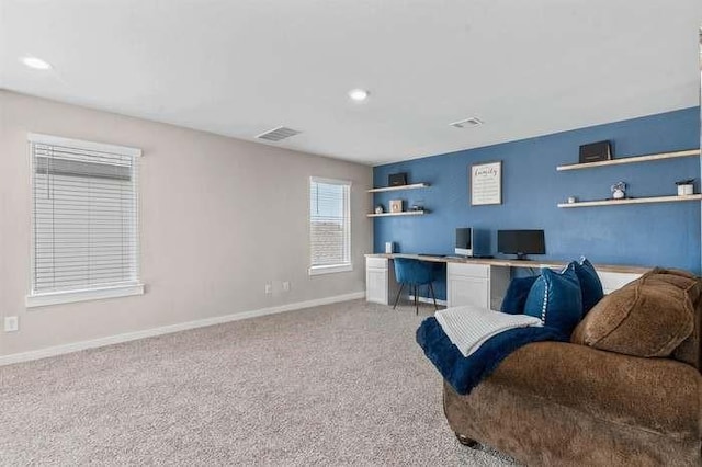 living area with recessed lighting, light carpet, visible vents, and baseboards