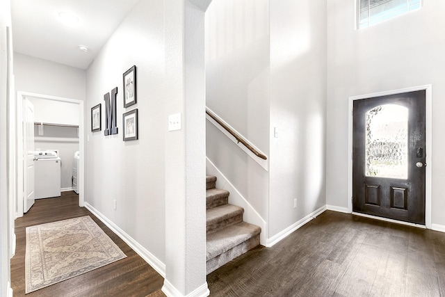 entryway with stairway, washing machine and dryer, baseboards, and dark wood-style flooring