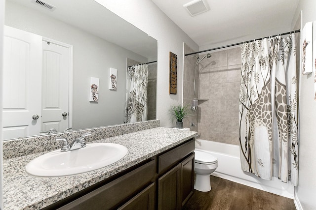 bathroom featuring shower / tub combo, visible vents, wood finished floors, and vanity