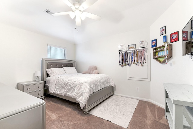 bedroom with a ceiling fan, visible vents, dark carpet, and baseboards