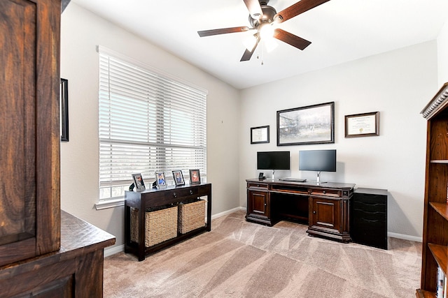 office area with light carpet, ceiling fan, and baseboards