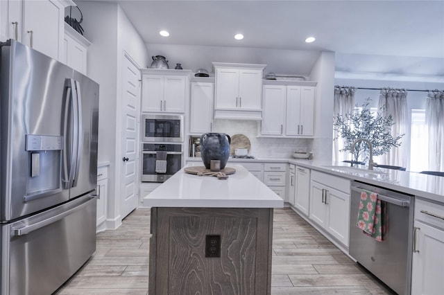 kitchen with white cabinets, light countertops, appliances with stainless steel finishes, and recessed lighting