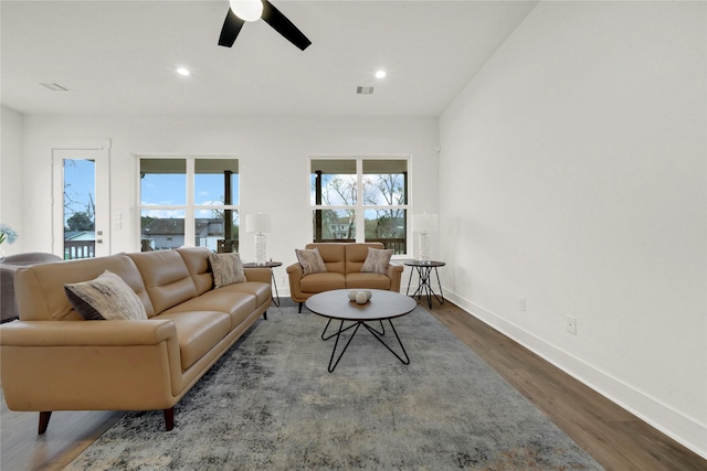 living area featuring a ceiling fan, wood finished floors, visible vents, and a wealth of natural light