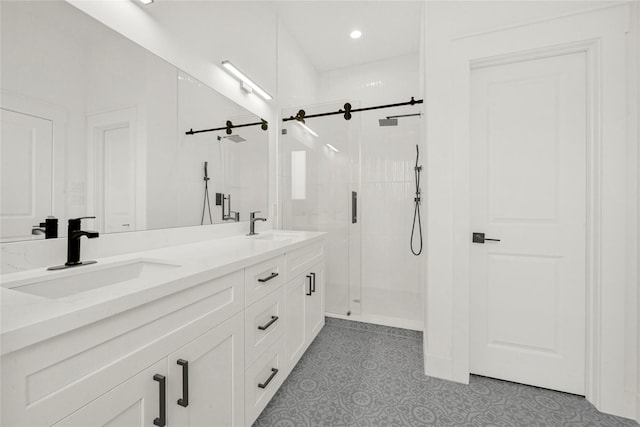 full bath with double vanity, a stall shower, and a sink