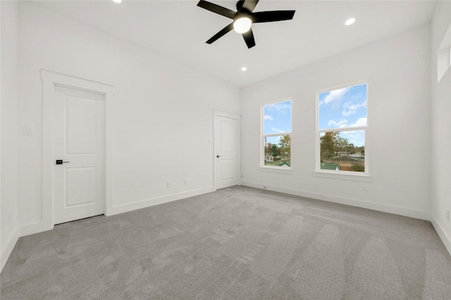 spare room featuring recessed lighting, baseboards, light carpet, and a ceiling fan