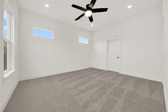 carpeted spare room with recessed lighting, a ceiling fan, and baseboards