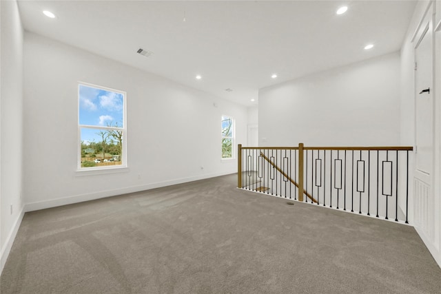 carpeted spare room featuring recessed lighting, visible vents, and baseboards