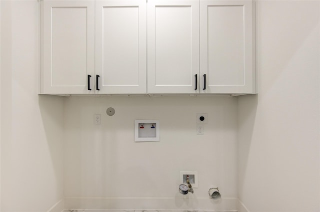 washroom featuring washer hookup, hookup for a gas dryer, cabinet space, baseboards, and hookup for an electric dryer