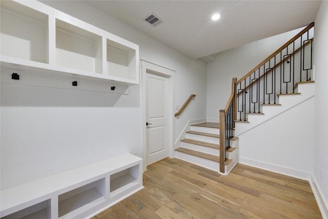 mudroom with recessed lighting, visible vents, light wood finished floors, and baseboards