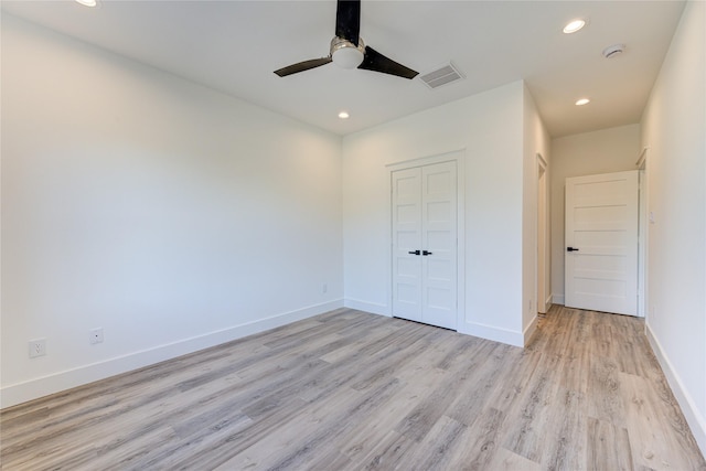 unfurnished bedroom with light wood finished floors, recessed lighting, a closet, visible vents, and baseboards