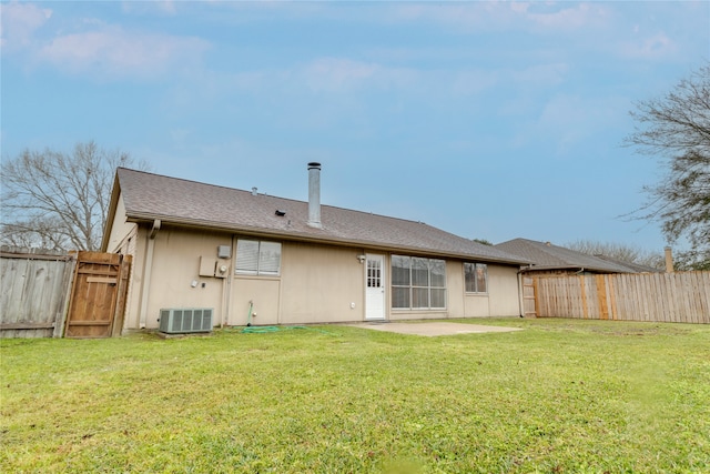 back of house with a yard, a patio area, cooling unit, and fence