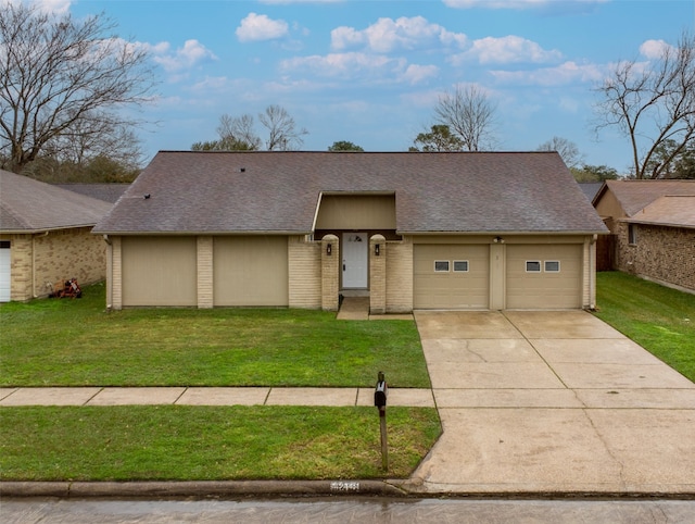 view of front of property featuring driveway, a garage, a front lawn, and roof with shingles